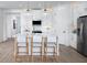 Contemporary kitchen with white cabinets, stainless steel appliances, island with seating, and modern lighting at 11795 Starbright Path, Venice, FL 34293