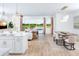 Open concept living and dining room with a view of the backyard, pool and lake at 11795 Starbright Path, Venice, FL 34293