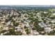 Aerial view of neighborhood featuring tree lined streets, homes, and the bay in the distance at 12299 91St N Ave, Seminole, FL 33772
