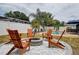 Backyard features a firepit with adirondack chairs next to the in-ground pool at 12299 91St N Ave, Seminole, FL 33772