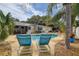 Lounge chairs overlook the in-ground pool in a spacious backyard oasis at 12299 91St N Ave, Seminole, FL 33772