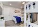 Bright bedroom featuring a single bed with a blue throw and white bunk beds with blue curtains at 12299 91St N Ave, Seminole, FL 33772
