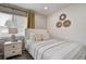 Charming bedroom features a single bed, decorative mirrors, and a stylish wallpaper accent wall at 12299 91St N Ave, Seminole, FL 33772