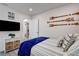 Comfortable bedroom featuring a single bed, wood-look floors and decorative oar artwork at 12299 91St N Ave, Seminole, FL 33772