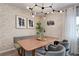 Charming dining room with modern lighting, farmhouse style table and unique exposed brick wall at 12299 91St N Ave, Seminole, FL 33772