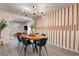 Dining room with wood accent wall, modern chandelier and view into living room and kitchen at 12299 91St N Ave, Seminole, FL 33772