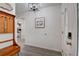 Bright foyer featuring stylish light fixture, wood-look floors, coat rack and view into a bedroom at 12299 91St N Ave, Seminole, FL 33772