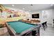 Bright game room with pool table, mural, couch and TV at 12299 91St N Ave, Seminole, FL 33772