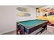 Fun game room featuring a pool table, beach mural, and surfboard decor at 12299 91St N Ave, Seminole, FL 33772