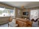 Inviting living room featuring exposed brick, ceiling fan and view of the outdoor space at 12299 91St N Ave, Seminole, FL 33772