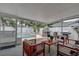 Covered patio featuring ample seating, a pizza oven, grill, and views of the inviting pool at 12299 91St N Ave, Seminole, FL 33772