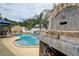 Beautiful pool with a wood-fired oven in a serene outdoor setting at 12299 91St N Ave, Seminole, FL 33772