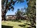 Spacious backyard featuring a large, mature tree providing shade, and a wooden fence for privacy at 12720 Four Oaks Rd, Tampa, FL 33624