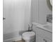 Bathroom featuring a white toilet, white shower curtain, and white cabinet with an ornate mirror at 12720 Four Oaks Rd, Tampa, FL 33624
