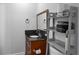 Bathroom featuring a black granite counter with a light wood vanity cabinet and grey shelf above the toilet at 12720 Four Oaks Rd, Tampa, FL 33624