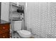 Bathroom featuring a gray shelf above the toilet and a white patterned shower curtain in a home at 12720 Four Oaks Rd, Tampa, FL 33624