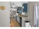 Kitchen featuring granite counters, stainless steel appliances, and blue upper and white lower cabinets at 12720 Four Oaks Rd, Tampa, FL 33624