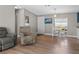 Living room features wood floors, neutral paint, furniture, and a window with natural light at 12720 Four Oaks Rd, Tampa, FL 33624