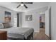 Bedroom features light grey walls, modern art, wood floors, ceiling fan, and a warm ambiance at 12720 Four Oaks Rd, Tampa, FL 33624