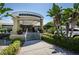 Exterior view of a restaurant entrance featuring lush landscaping and architectural details at 1335 Lahara Way, Trinity, FL 34655