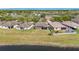 Aerial view of the home's backyard and community, bordering a pond at 13820 Chalk Hill Pl, Riverview, FL 33579