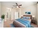 Staged bedroom with contemporary furniture, decor and a large ceiling fan at 13820 Chalk Hill Pl, Riverview, FL 33579