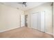 Bedroom with neutral carpet and paint, ceiling fan, and access to closet at 13820 Chalk Hill Pl, Riverview, FL 33579