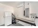 Functional garage space with white walls, a utility sink, shelving, and air conditioning unit at 13820 Chalk Hill Pl, Riverview, FL 33579