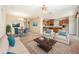 Staged living room with neutral carpeting, modern furniture, adjacent to dining area and kitchen at 13820 Chalk Hill Pl, Riverview, FL 33579