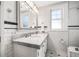 Bathroom with dual sinks, subway tile, black and white mosaic floors, and glass-enclosed shower at 1505 Beach Ne Dr, St Petersburg, FL 33704