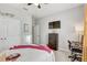 View of a bedroom featuring a carpeted floor, TV, desk, ceiling fan and closet for ample storage at 16625 Goose Ribbon Pl, Wimauma, FL 33598