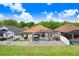 Aerial view of a private backyard with a screened-in pool and a white fence at 16843 Harrierridge Pl, Lithia, FL 33547