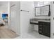 Bathroom featuring hexagon tile floors, granite countertop, a dark cabinet and mirror at 16843 Harrierridge Pl, Lithia, FL 33547