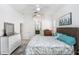 Bright bedroom featuring a king-sized bed, white walls, and light-colored wood floors at 16843 Harrierridge Pl, Lithia, FL 33547