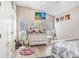 Bedroom features a large dresser, ceiling fan, laminate floors, and a comfortable bed at 16843 Harrierridge Pl, Lithia, FL 33547
