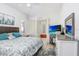 Serene bedroom with a large bed, bright white walls, ceiling fan, and decorative touches at 16843 Harrierridge Pl, Lithia, FL 33547