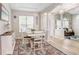 Bright dining room with a stylish rug, wooden floors, and a table for four at 16843 Harrierridge Pl, Lithia, FL 33547