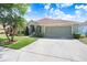 A well-maintained one-story home with an attached garage and a long driveway for parking at 16843 Harrierridge Pl, Lithia, FL 33547
