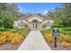 Clubhouse entrance with manicured landscaping and a sign for the community fitness center at 16843 Harrierridge Pl, Lithia, FL 33547