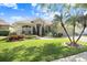 Charming one-story home featuring a lush lawn and inviting curb appeal with manicured landscaping at 16843 Harrierridge Pl, Lithia, FL 33547