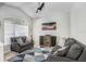 Comfortable living room area featuring vaulted ceilings, a ceiling fan, and plush seating at 16843 Harrierridge Pl, Lithia, FL 33547