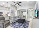 Inviting living room with open layout, ceiling fan, and stylish decor that creates a cozy atmosphere at 16843 Harrierridge Pl, Lithia, FL 33547