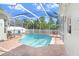 Screened in pool featuring brick pavers, an outdoor seating area, and a beautifully landscaped backyard at 16843 Harrierridge Pl, Lithia, FL 33547