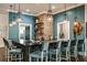 Stylish bar area featuring a black countertop, tile accents, and pendant lighting at 16948 Falling Waters Ct, Land O Lakes, FL 34638