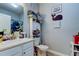 Compact bathroom featuring a vanity, toilet, and an octopus-themed shower curtain at 17965 Villa Creek Dr, Tampa, FL 33647