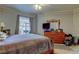 Cozy bedroom features a large window, dresser, and a comfortable bed at 17965 Villa Creek Dr, Tampa, FL 33647