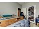 Bedroom with a bed covered with a blanket and boxes, a desk in a box, chair and shoe rack at 17965 Villa Creek Dr, Tampa, FL 33647