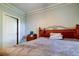 Simple bedroom features a comfortable bed with a wooden headboard, adjacent to a closet at 17965 Villa Creek Dr, Tampa, FL 33647