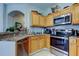 Functional kitchen featuring stainless steel appliances and light wood cabinets at 17965 Villa Creek Dr, Tampa, FL 33647