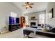 Bright living room features a ceiling fan, fireplace, and a comfortable sectional sofa at 17965 Villa Creek Dr, Tampa, FL 33647